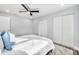 This bedroom has hardwood floors, neutral paint, a ceiling fan, and large closet at 1811 Forest Dr, Oldsmar, FL 34677