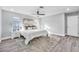 This bedroom features hardwood floors, neutral paint and carpet, a ceiling fan and plenty of natural light at 1811 Forest Dr, Oldsmar, FL 34677