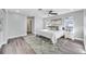 This bedroom features hardwood floors, neutral paint and carpet, a ceiling fan and plenty of natural light at 1811 Forest Dr, Oldsmar, FL 34677