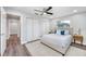 This bedroom features hardwood floors, neutral paint and carpet, a ceiling fan, and a walk-in closet at 1811 Forest Dr, Oldsmar, FL 34677