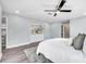 This bedroom features hardwood floors, neutral paint and carpet, a ceiling fan and plenty of natural light at 1811 Forest Dr, Oldsmar, FL 34677