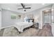 Bright bedroom with large windows, ceiling fan and neutral decor at 1811 Forest Dr, Oldsmar, FL 34677
