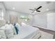 This bedroom features hardwood floors, neutral paint and carpet, a ceiling fan and plenty of natural light at 1811 Forest Dr, Oldsmar, FL 34677