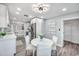 Eat-in kitchen with white round dining table and modern lighting fixture at 1811 Forest Dr, Oldsmar, FL 34677