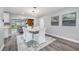Dining area featuring hardwood floors, modern lighting, and seamless flow to the living space at 1811 Forest Dr, Oldsmar, FL 34677