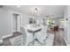Elegant dining room with hardwood floors, modern lighting, and views into the front living space at 1811 Forest Dr, Oldsmar, FL 34677