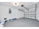 Spacious garage with epoxy floors, a clean interior, and an automatic door for convenient parking and storage at 1811 Forest Dr, Oldsmar, FL 34677