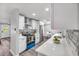 Modern kitchen featuring white cabinets, stainless steel appliances, and stone backsplash at 1811 Forest Dr, Oldsmar, FL 34677