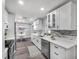 Bright kitchen features white cabinetry, stainless steel appliances, and a stylish gray backsplash at 1811 Forest Dr, Oldsmar, FL 34677