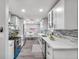 Bright kitchen features white cabinetry, stainless steel appliances, and a stylish gray backsplash at 1811 Forest Dr, Oldsmar, FL 34677