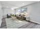 Bright living room with large windows, fireplace, and neutral-toned furniture at 1811 Forest Dr, Oldsmar, FL 34677