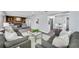 Bright living room with large windows, fireplace, and neutral-toned furniture at 1811 Forest Dr, Oldsmar, FL 34677