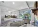 Bright living room with large windows, fireplace, and views of the pool at 1811 Forest Dr, Oldsmar, FL 34677
