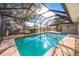 Beautiful backyard pool surrounded by a screened enclosure, offering a relaxing and private outdoor experience at 1811 Forest Dr, Oldsmar, FL 34677
