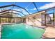 Stunning backyard pool enclosed with a screened lanai, perfect for swimming and outdoor entertaining at 1811 Forest Dr, Oldsmar, FL 34677