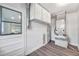 Well-organized utility room with modern flooring, white cabinetry, and essential appliances for home maintenance at 1811 Forest Dr, Oldsmar, FL 34677