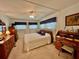 Cozy bedroom featuring a wooden bed frame, matching furniture, and a ceiling fan at 205 Seagull N Dr, Tarpon Springs, FL 34689