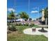 Common area with a shuffleboard court, tables, benches, and landscaping at 205 Seagull N Dr, Tarpon Springs, FL 34689