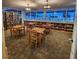 Inviting community library with books, tables, chairs, and large windows overlooking the pool at 205 Seagull N Dr, Tarpon Springs, FL 34689