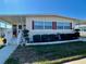 Charming single-story home featuring a covered porch, well-maintained lawn, and neat landscaping at 205 Seagull N Dr, Tarpon Springs, FL 34689
