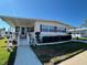 Charming home with manicured lawn and covered porch at 205 Seagull N Dr, Tarpon Springs, FL 34689