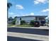 Charming home featuring a covered carport, well-maintained landscaping, and proximity to community offices at 205 Seagull N Dr, Tarpon Springs, FL 34689