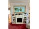 Living room fireplace featuring a decorative painting and built-in shelves at 205 Seagull N Dr, Tarpon Springs, FL 34689
