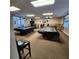 Community game room with two covered pool tables and various tables and chairs at 205 Seagull N Dr, Tarpon Springs, FL 34689