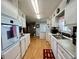 Functional galley kitchen with ample cabinet space, modern appliances, and easy access to dining at 205 Seagull N Dr, Tarpon Springs, FL 34689
