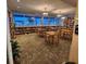 Community library with several tables and chairs surrounded by floor-to-ceiling bookshelves at 205 Seagull N Dr, Tarpon Springs, FL 34689
