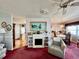 Cozy living room with a fireplace and view into dining area at 205 Seagull N Dr, Tarpon Springs, FL 34689