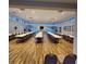 Large meeting room with rows of tables and chairs, wood flooring, and many windows at 205 Seagull N Dr, Tarpon Springs, FL 34689