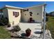 This patio features a red chair and a decorative palm tree, providing a cozy outdoor space for relaxation at 205 Seagull N Dr, Tarpon Springs, FL 34689