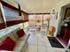 Bright sunroom with tiled floors, plenty of windows, and comfortable wicker furniture at 205 Seagull N Dr, Tarpon Springs, FL 34689