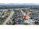 An aerial view showcases a neighborhood with community pool and a serene lake nearby at 4375 Barletta Ct, Wesley Chapel, FL 33543