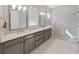 This is a spacious bathroom featuring a double vanity and a glass-enclosed shower at 4375 Barletta Ct, Wesley Chapel, FL 33543