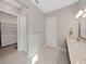 This bathroom features a granite countertop and an open walk-in closet at 4375 Barletta Ct, Wesley Chapel, FL 33543