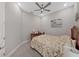 A cozy bedroom features a ceiling fan and a beautiful painting at 4375 Barletta Ct, Wesley Chapel, FL 33543