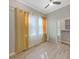 Bedroom with wood-look tile floors, ceiling fan and a closet with a frosted sliding glass door at 4375 Barletta Ct, Wesley Chapel, FL 33543