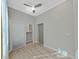 Bedroom with wood-look tile floors, ceiling fan and a closet with a frosted sliding glass door at 4375 Barletta Ct, Wesley Chapel, FL 33543