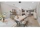 Dining room adjacent to kitchen, is fully furnished with modern decor and chandelier lighting at 4375 Barletta Ct, Wesley Chapel, FL 33543