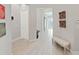 Light-filled entryway boasting stylish flooring, classic wainscoting, and tasteful decor at 4375 Barletta Ct, Wesley Chapel, FL 33543