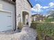 Exterior of home featuring a stone archway and decorative details enhancing its curb appeal at 4375 Barletta Ct, Wesley Chapel, FL 33543