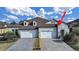 Charming home featuring a stone entryway, manicured landscaping, and a two-car garage at 4375 Barletta Ct, Wesley Chapel, FL 33543