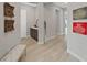 Hallway featuring wood-look tile floors, decorative artwork, and a convenient built-in vanity area at 4375 Barletta Ct, Wesley Chapel, FL 33543