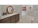 Hallway featuring wood-look tile floors and a convenient built-in vanity area with a marble countertop at 4375 Barletta Ct, Wesley Chapel, FL 33543