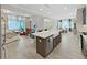 Open-concept kitchen featuring an island with seating and view of the living and dining area at 4375 Barletta Ct, Wesley Chapel, FL 33543