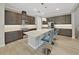 Gorgeous eat-in kitchen with stainless steel appliances, modern fixtures, and a center island with seating at 4375 Barletta Ct, Wesley Chapel, FL 33543