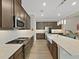 This kitchen is equipped with stainless steel appliances, a gas range, and a breakfast bar at 4375 Barletta Ct, Wesley Chapel, FL 33543