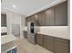 Modern kitchen with stainless steel refrigerator, stone countertops, and wood flooring at 4375 Barletta Ct, Wesley Chapel, FL 33543